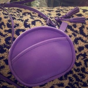 Purple leather coach crossbody purse.